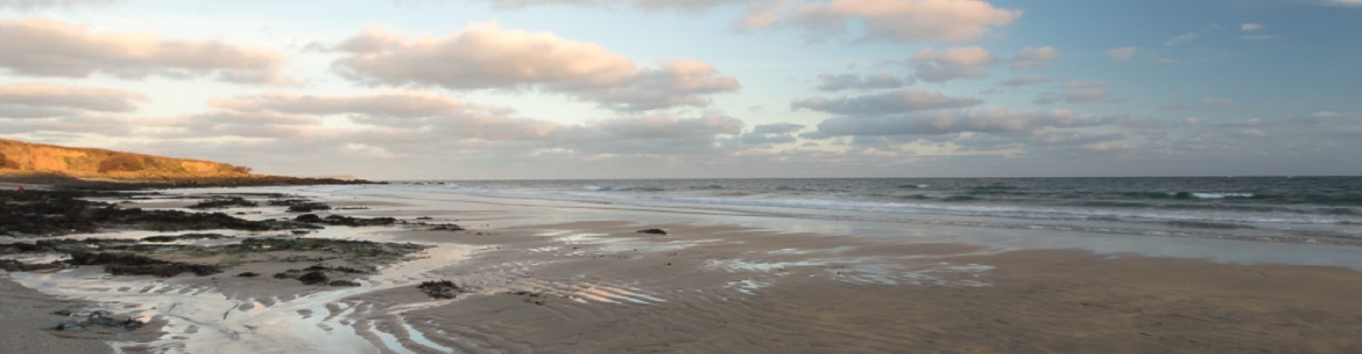 About_headerimage Sunset over a beach